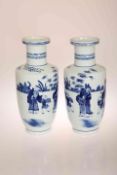 A NEAR PAIR OF CHINESE BLUE AND WHITE ROULEAU VASES, each painted with figures,
