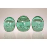 A GROUP OF THREE GREEN GLASS "DUMP" PAPERWEIGHTS, THIRD QUARTER 19th CENTURY,