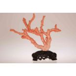 A CHINESE CARVED RED CORAL FIGURE GROUP, the branches modelled as two women,