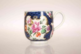 A WORCESTER SCALE BLUE GROUND COFFEE CUP, CIRCA 1770, enamelled with panels of flowers and gilded,