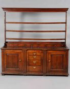 A GOOD GEORGE III OAK DRESSER AND RACK, the open rack with three shelves and moulded cornice,