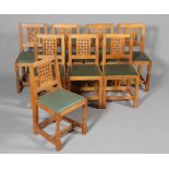 ROBERT THOMPSON OF KILBURN, A SET OF EIGHT MOUSEMAN OAK DINING CHAIRS, each with lattice back,