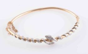 A LATE VICTORIAN DIAMOND SET BANGLE, set to the top section with two snakes,