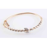 A LATE VICTORIAN DIAMOND SET BANGLE, set to the top section with two snakes,