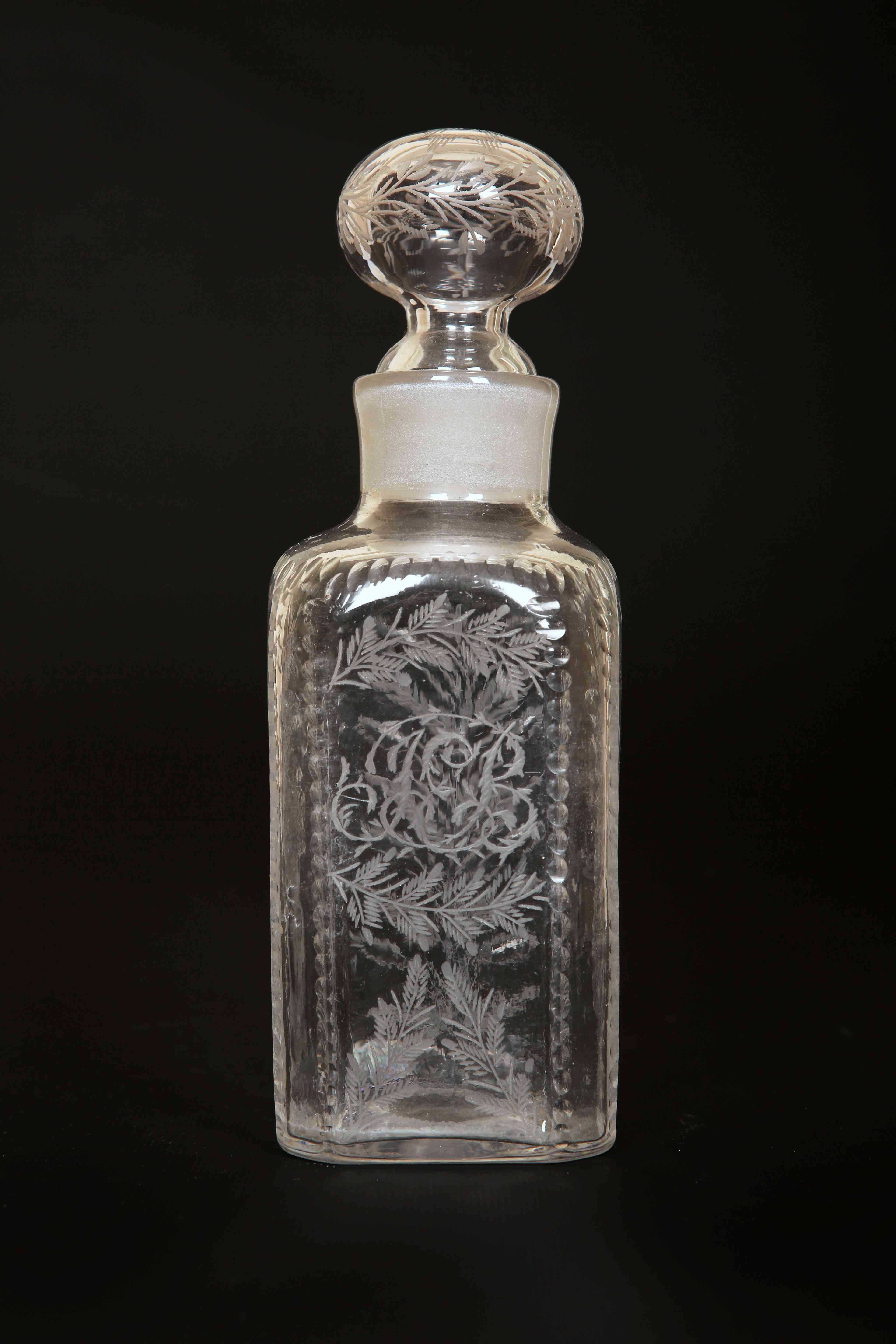 AN EARLY 19th CENTURY ENGRAVED GLASS DECANTER, of square form,