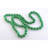 A JADEITE BEAD NECKLACE,