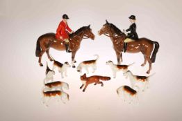 A BESWICK POTTERY HUNTING GROUP, comprising huntsman in a red coat and huntswoman in a black coat,