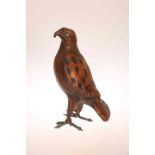 AN UNUSUAL LEATHER MODEL OF A HAWK, modelled standing upright.