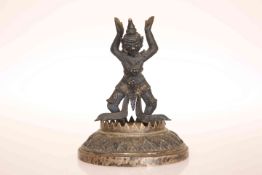 A SINO-TIBETAN BRONZE FIGURE, cast with arms aloft and bent at the knee,