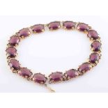 A PASTE AND GILT METAL NECKLACE, the sixteen large oval purple coloured paste stones,