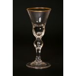 A LARGE 18TH CENTURY FOLDED FOOT WINE GLASS, with ball knop containing a tear drop,
