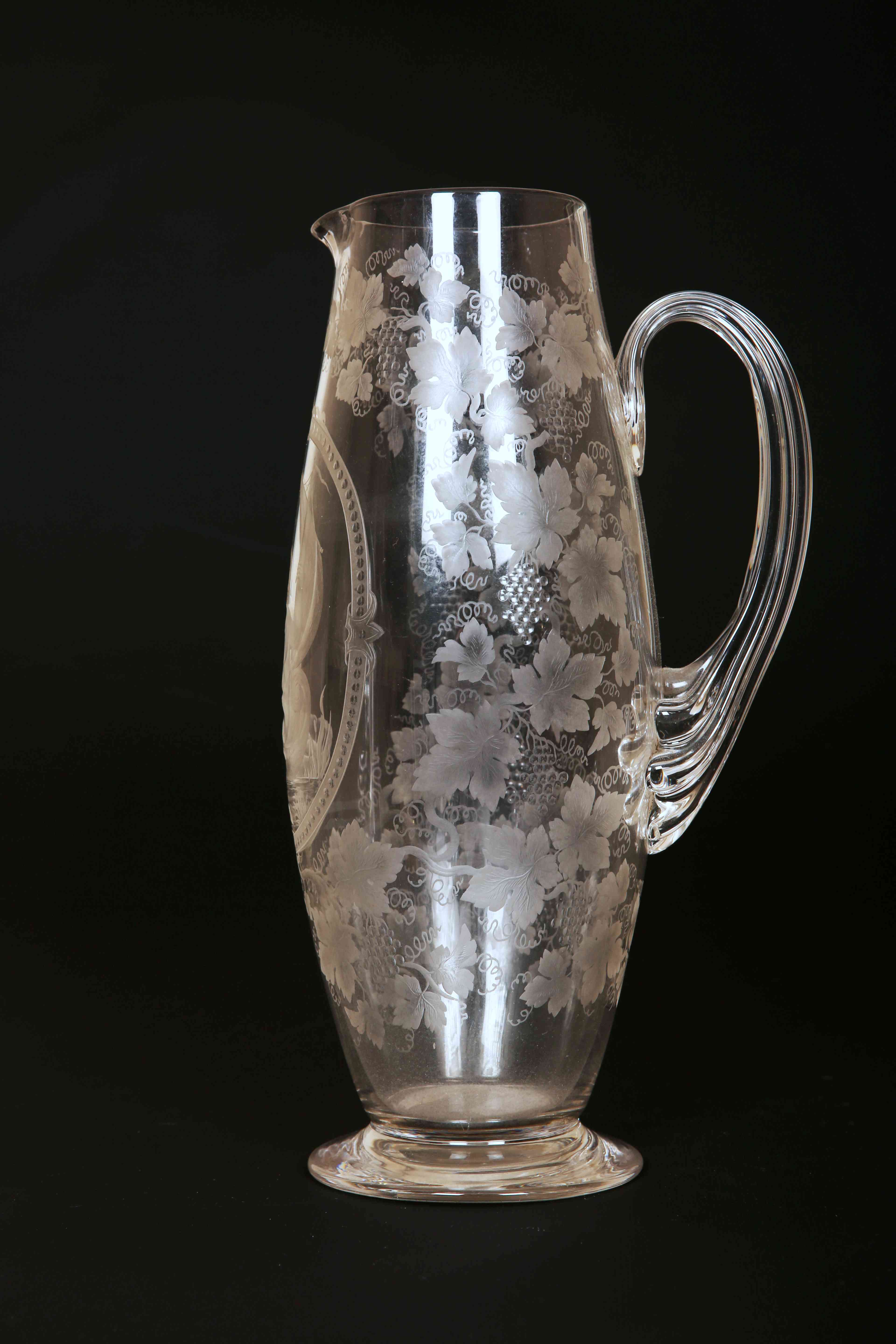 A 19TH CENTURY STOURBRIDGE ENGRAVED GLASS JUG, of slender ovoid form,