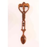 A WELSH CARVED LOVING SPOON, with entwined hearts terminal. 22.