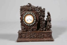 AN UNUSUAL CARVED OAK MANTEL CLOCK, 19TH CENTURY, boldly carved with foliage,