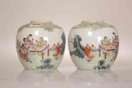 A PAIR OF CHINESE FAMILLE ROSE JARS, each enamel painted with figures at a table taking tea. 12.