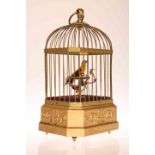 A SINGING BIRD AUTOMATON, LATE 19TH/EARLY 20TH CENTURY, in gilt wirework cage,