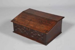 AN OAK BIBLE BOX, LATE 17TH/EARLY 18TH CENTURY, with hinged slope and carved front.
