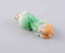 A JADEITE PENDANT, carved to depict a sleeping Chinese dragon,