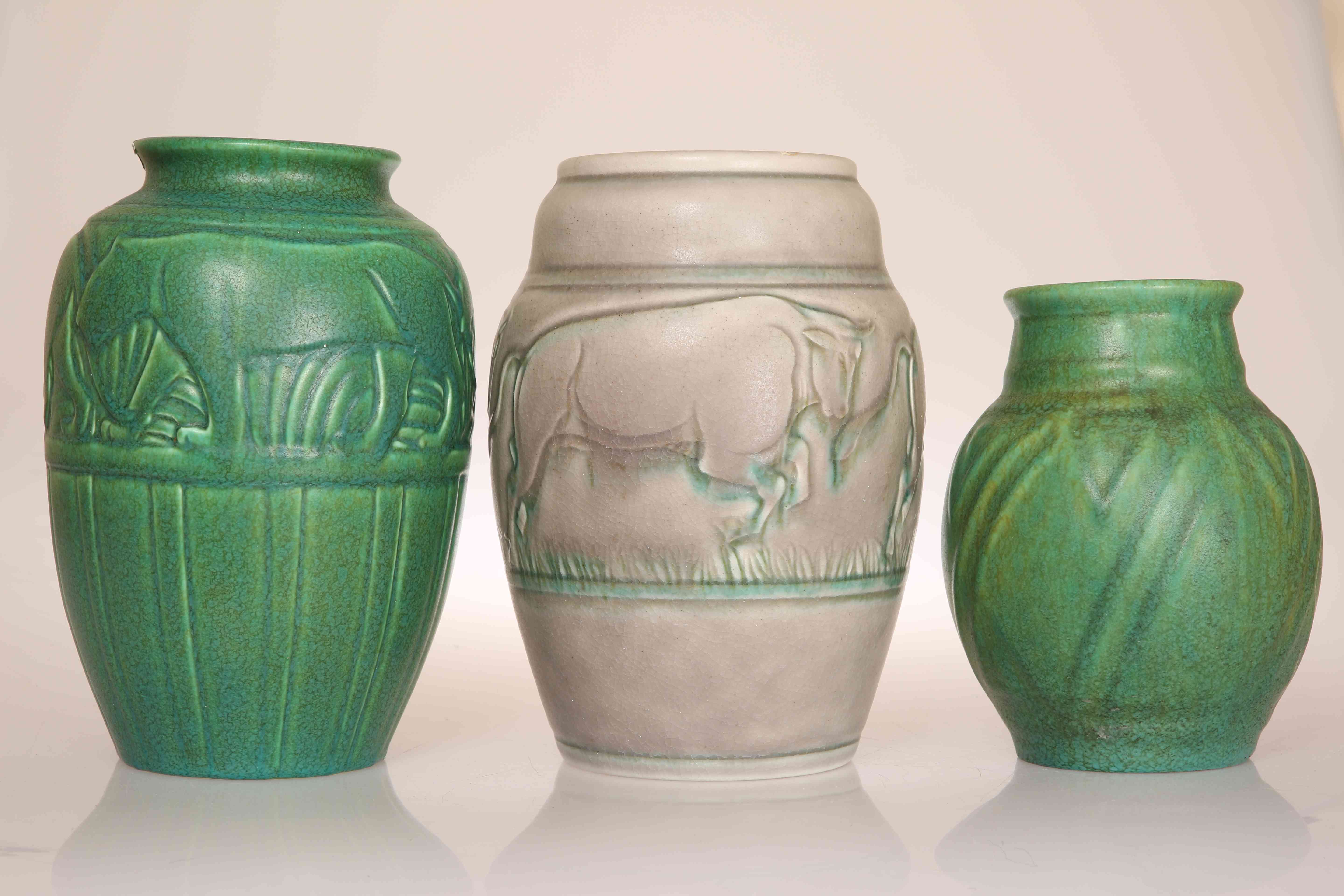THREE PILKINGTONS ROYAL LANCASTRIAN VASES, the first modelled with a frieze of charging bulls,