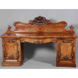 A WILLIAM IV MAHOGANY PEDESTAL SIDEBOARD, with boldly scrolling backboard with foliate carved crest,