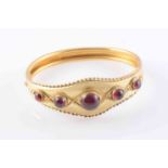 A MID VICTORIAN GARNET SET BANGLE,