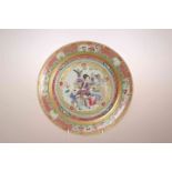 A CHINESE EXPORT FAMILLE ROSE PLATE, painted to the well with a teacher and two boys in an interior.