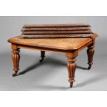 A LARGE VICTORIAN MAHOGANY WINDOUT EXTENDING DINING TABLE, the moulded top with rounded corners,