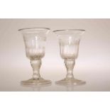 A PAIR OF GEORGIAN FOLDED FOOT GIN GLASSES, with bell bowls cut with leaves.