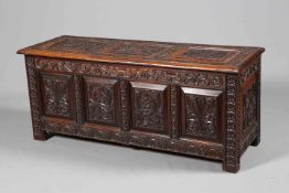 A LARGE CARVED OAK COFFER, 19TH CENTURY, the three-panel lid carved with lozenges,