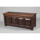 A LARGE CARVED OAK COFFER, 19TH CENTURY, the three-panel lid carved with lozenges,