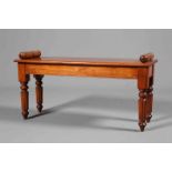 A MAHOGANY WINDOW SEAT IN WILLIAM IV STYLE, raised on reeded legs.