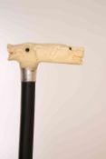 AN IVORY HANDLED, SILVER COLLARED AND EBONISED WALKING CANE, London 1926,