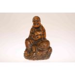 A CHINESE CARVED SOAPSTONE FIGURE OF A SEATED LOHAN,