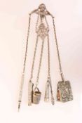 A LATE VICTORIAN SILVER AND WHITE METAL CHATELAINE,