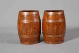 A PAIR OF COOPERED OAK BARRELS, with copper bands, early 20th Century.