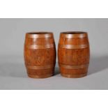 A PAIR OF COOPERED OAK BARRELS, with copper bands, early 20th Century.