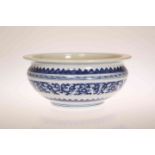 A CHINESE BLUE AND WHITE BOWL, of squat circular form, with flanged rim,