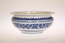 A CHINESE BLUE AND WHITE BOWL, of squat circular form, with flanged rim,