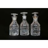 A SET OF THREE GEORGE III ENGRAVED AND CUT-GLASS CRUET BOTTLES, each of mallet form,