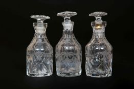 A SET OF THREE GEORGE III ENGRAVED AND CUT-GLASS CRUET BOTTLES, each of mallet form,