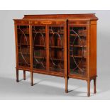 AN EDWARDIAN INLAID MAHOGANY BREAKFRONT BOOKCASE, with astragal glazed doors,