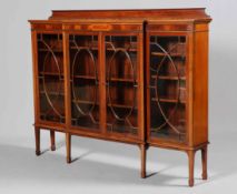 AN EDWARDIAN INLAID MAHOGANY BREAKFRONT BOOKCASE, with astragal glazed doors,