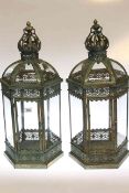 Pair of ornate metal and glazed hexagonal hall lanterns