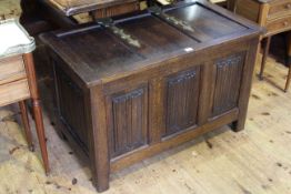 17th Century style oak linen fold panel front coffer with large brass Gothic style strap hinges, 91.