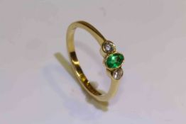 18 carat yellow gold oval emerald and round brilliant diamond three stone ring