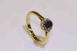18 carat yellow gold oval sapphire and round brilliant diamond cluster ring