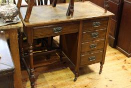 Late Victorian five drawer writing desk with leather inset top,