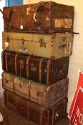 Five vintage canvas bound travelling trunks