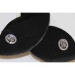 18 carat gold oval diamond and round brilliant diamond cluster earrings, diamonds approximately 0.