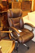 Brown stitched leather swivel armchair